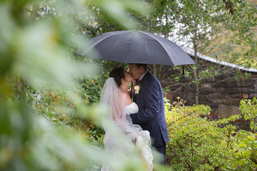 Rainy wedding day photos in the gardens of the Chanler at Cliff Walk in Newport Rhode Island.