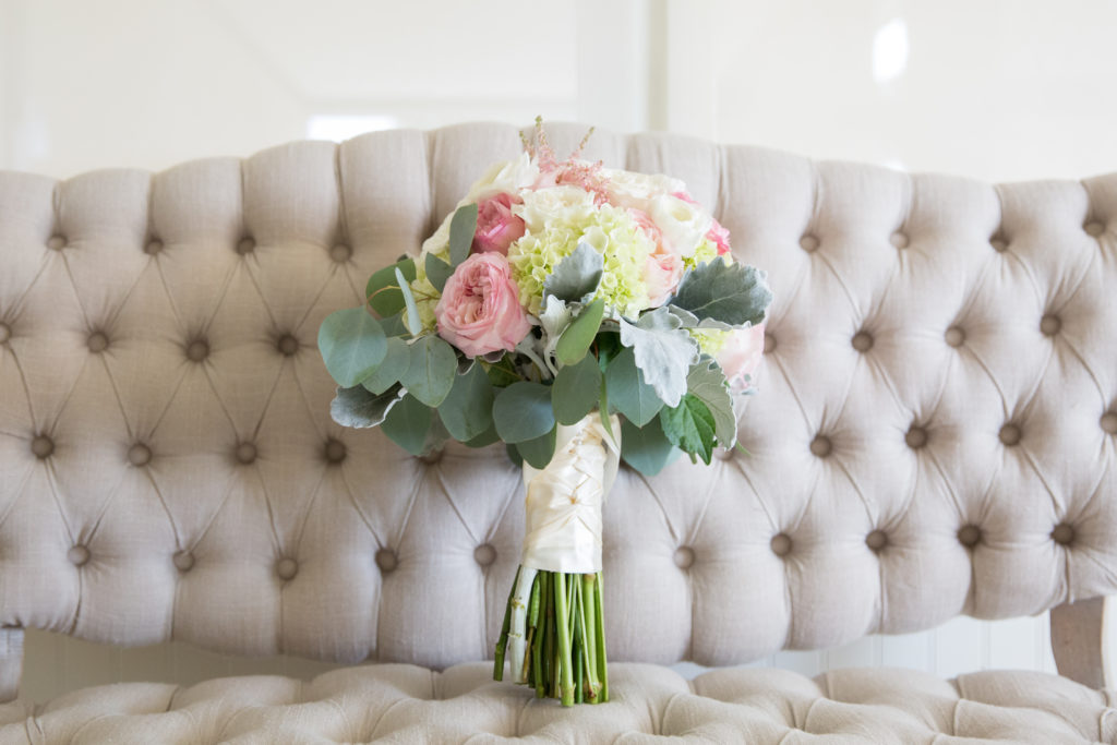 Bridal bouquet featuring blush and white flowers. 