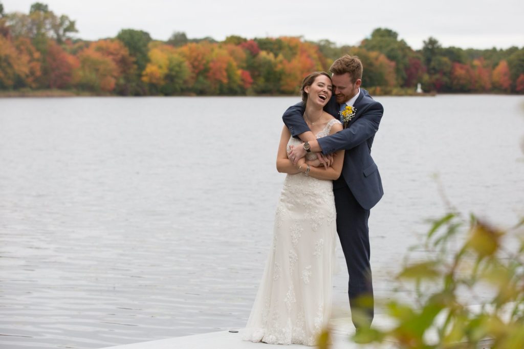 Bride and Groom embrace on the docks of Crystal Lake Country Club in Mapleville RI.
