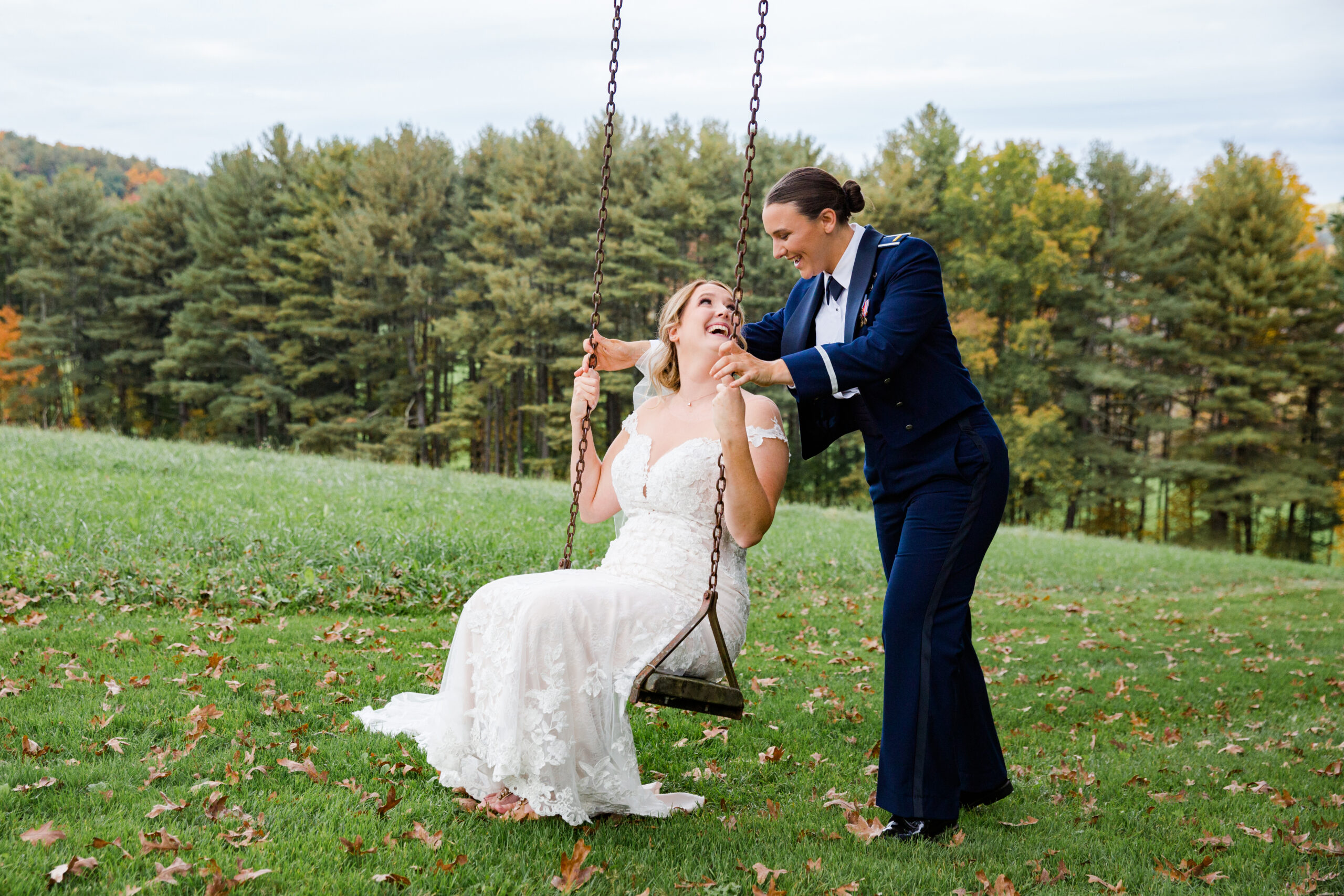 A Bride takes a ride on a swing at Zukas Hilltop Barn