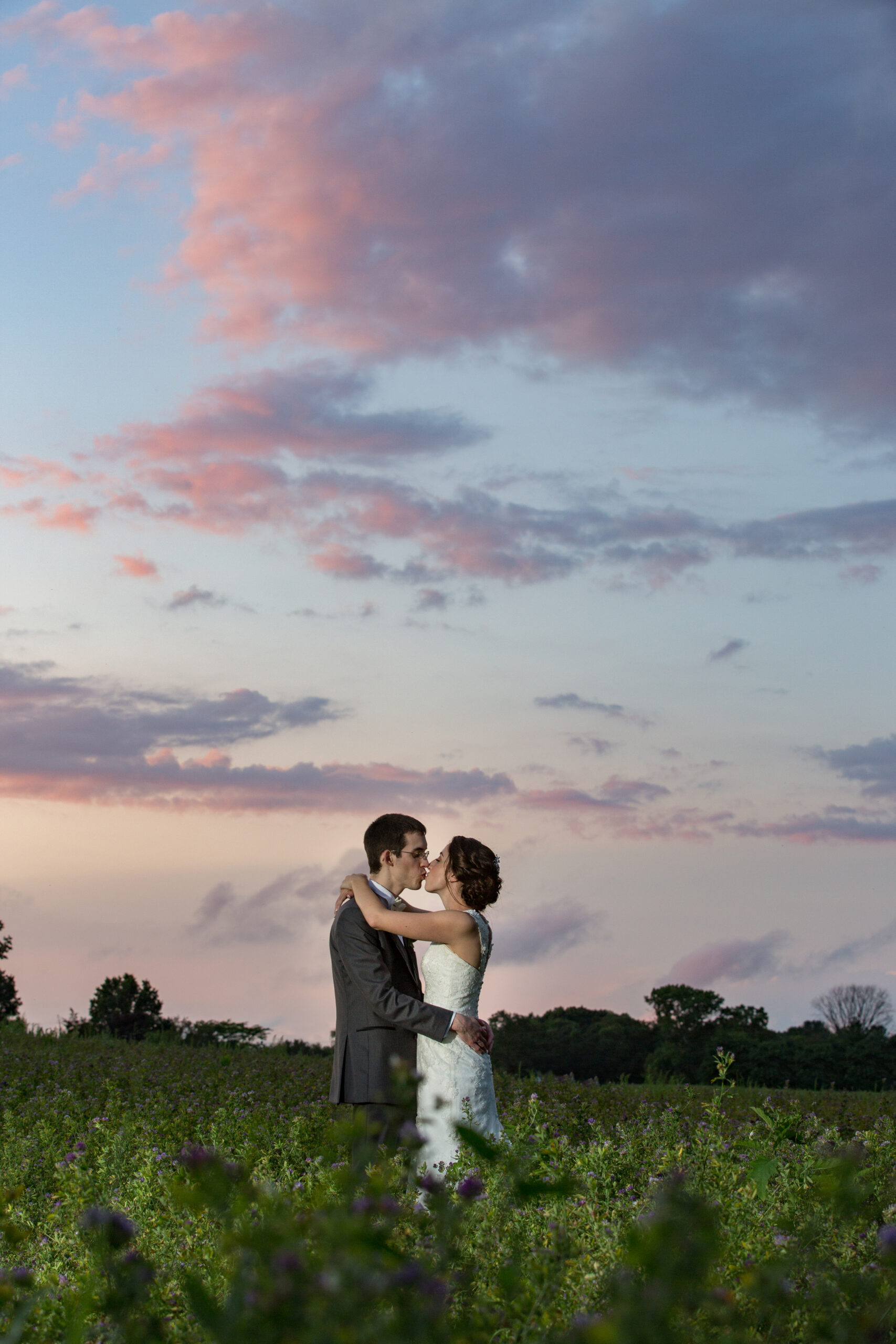 A bride and Groom Share a kiss at Chamberlain Farms in Berkley MA.
