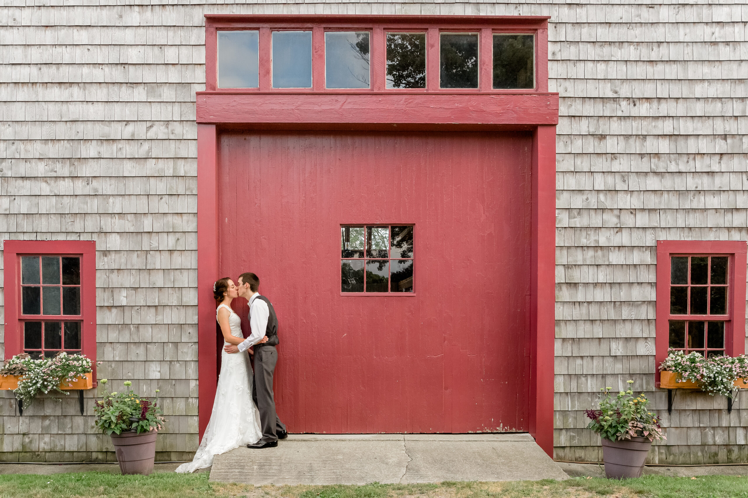 A bride and Groom share a kiss on their wedding day at Chamberlain Farms in Berkley MA.
