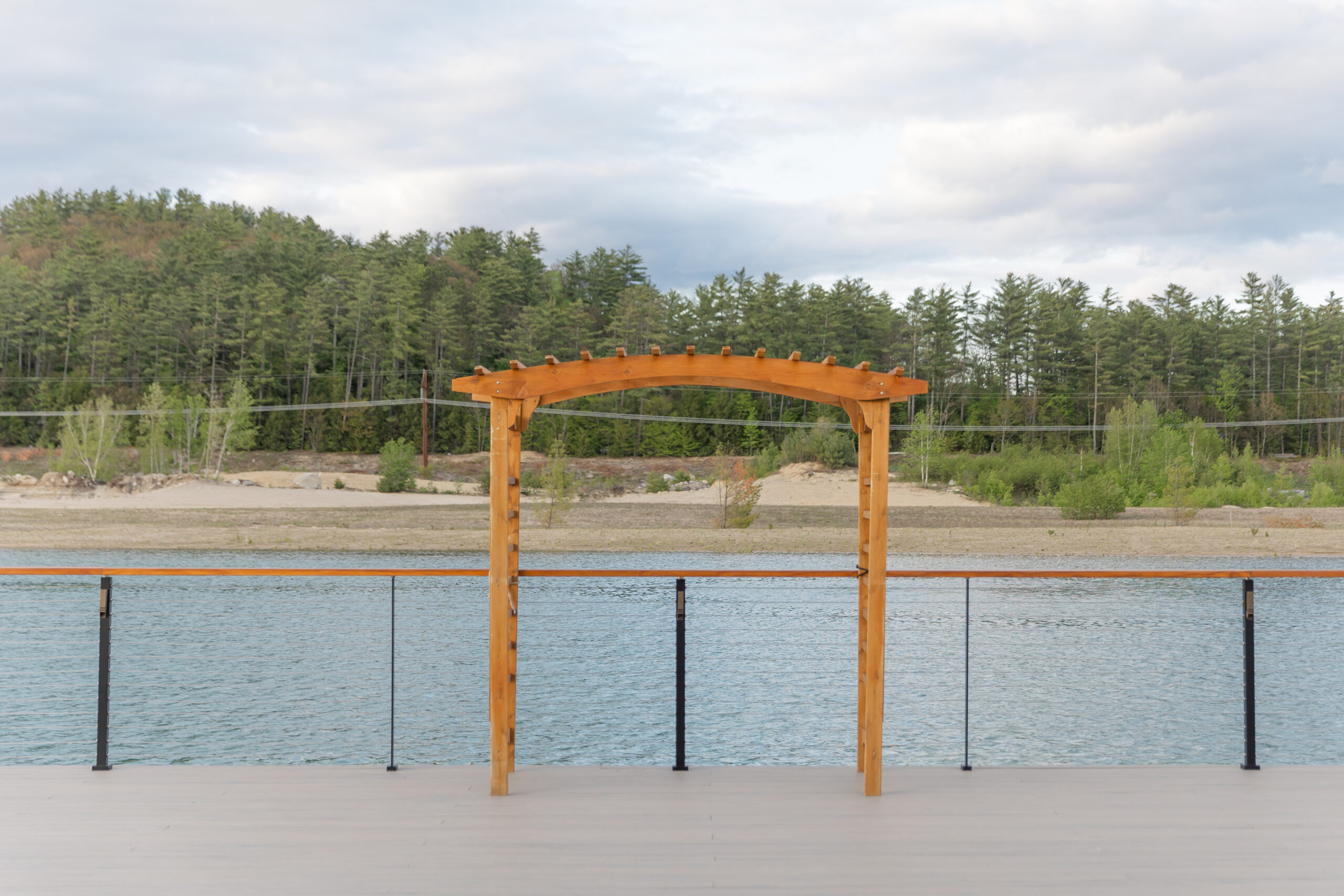 The outdoor deck at the Lake House overlooks the lake and a Pine Knoll in the background. 