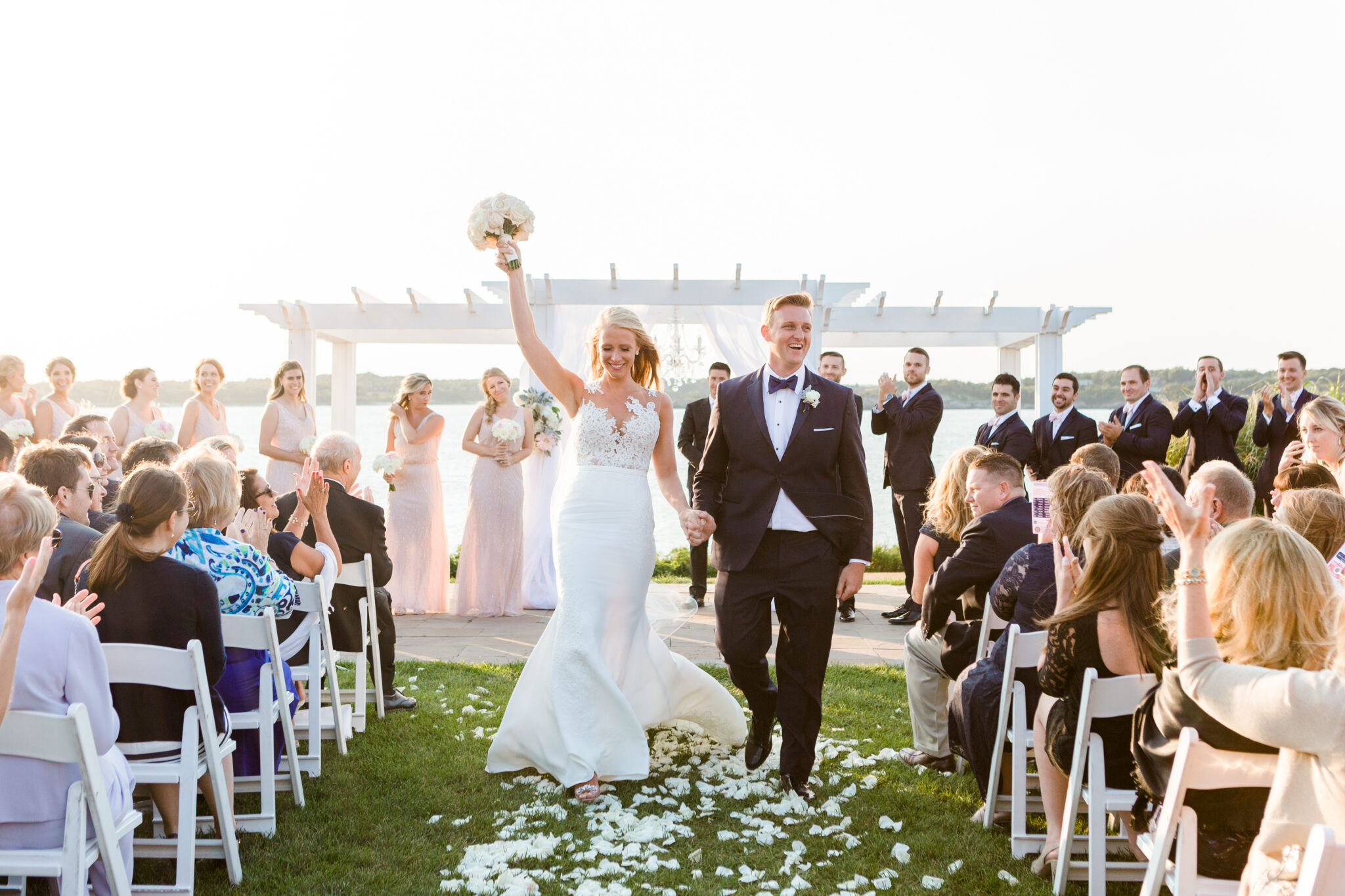 Newlyweds celebrate at the outdoor ceremony site at OceanCliff in Newport RI