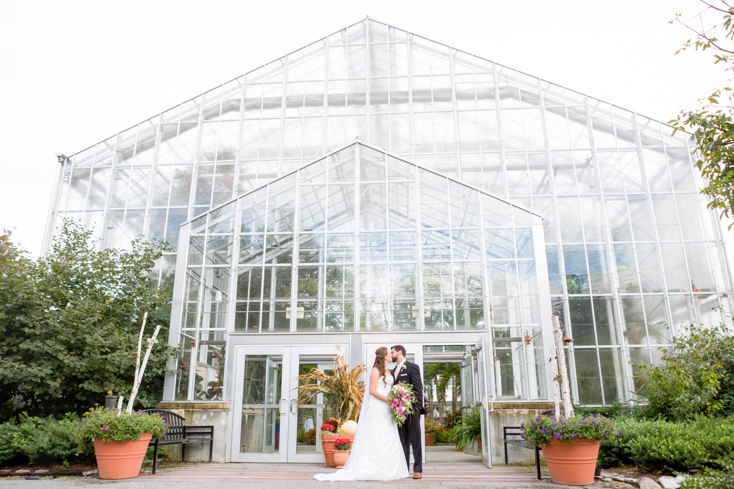 A bride and groom share a moment outside the Green House entrance at Roger Williams Botanical Center in Providence Rhode Island. 