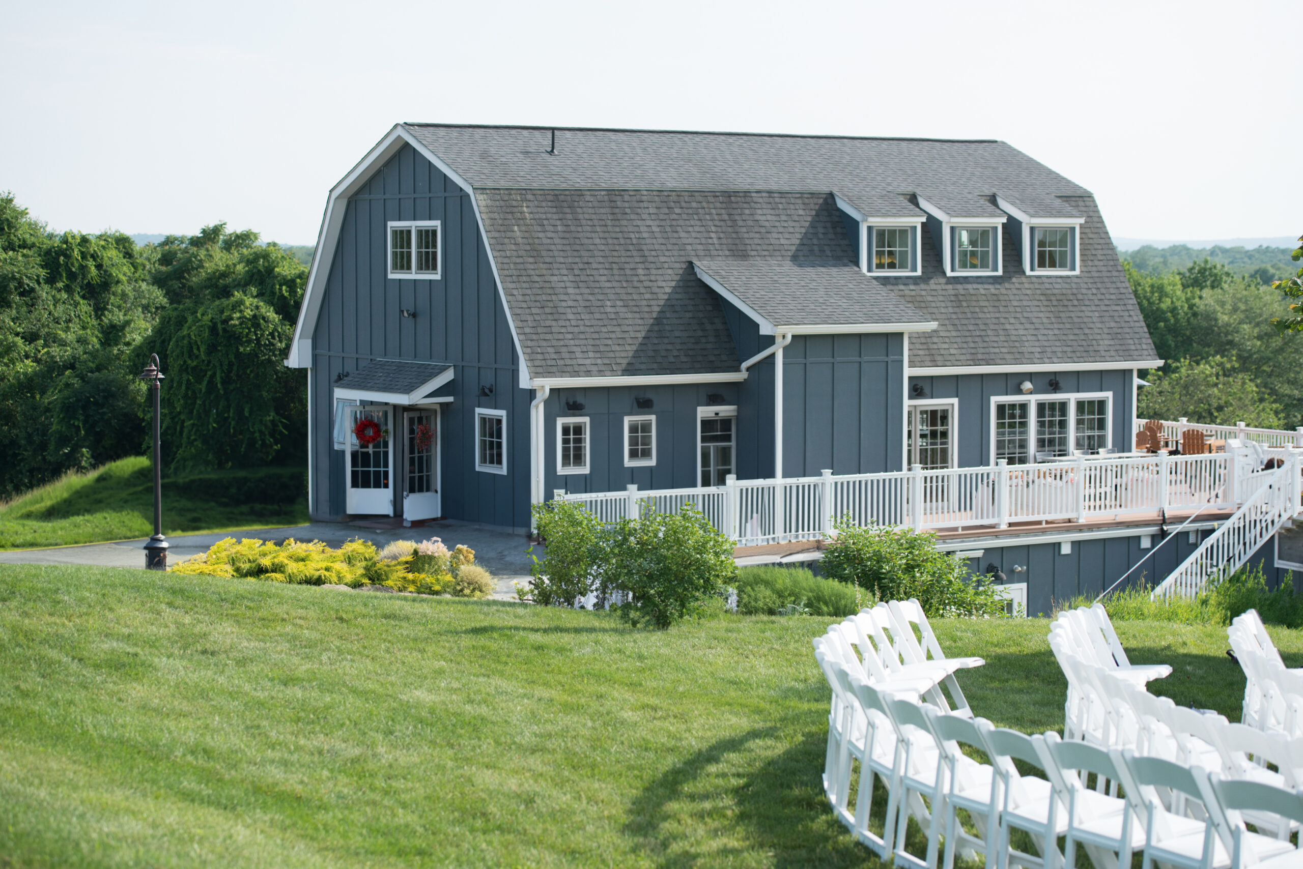 The Tasting Barn and the adjacent deck offer a quintessential backdrop to the outdoor ceremony space at Preston Ridge Vineyard.