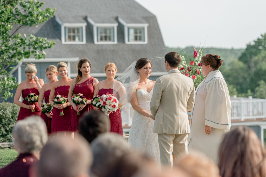 A wedding ceremony takes place outside the barn at Preston Ridge Vineyard. 
