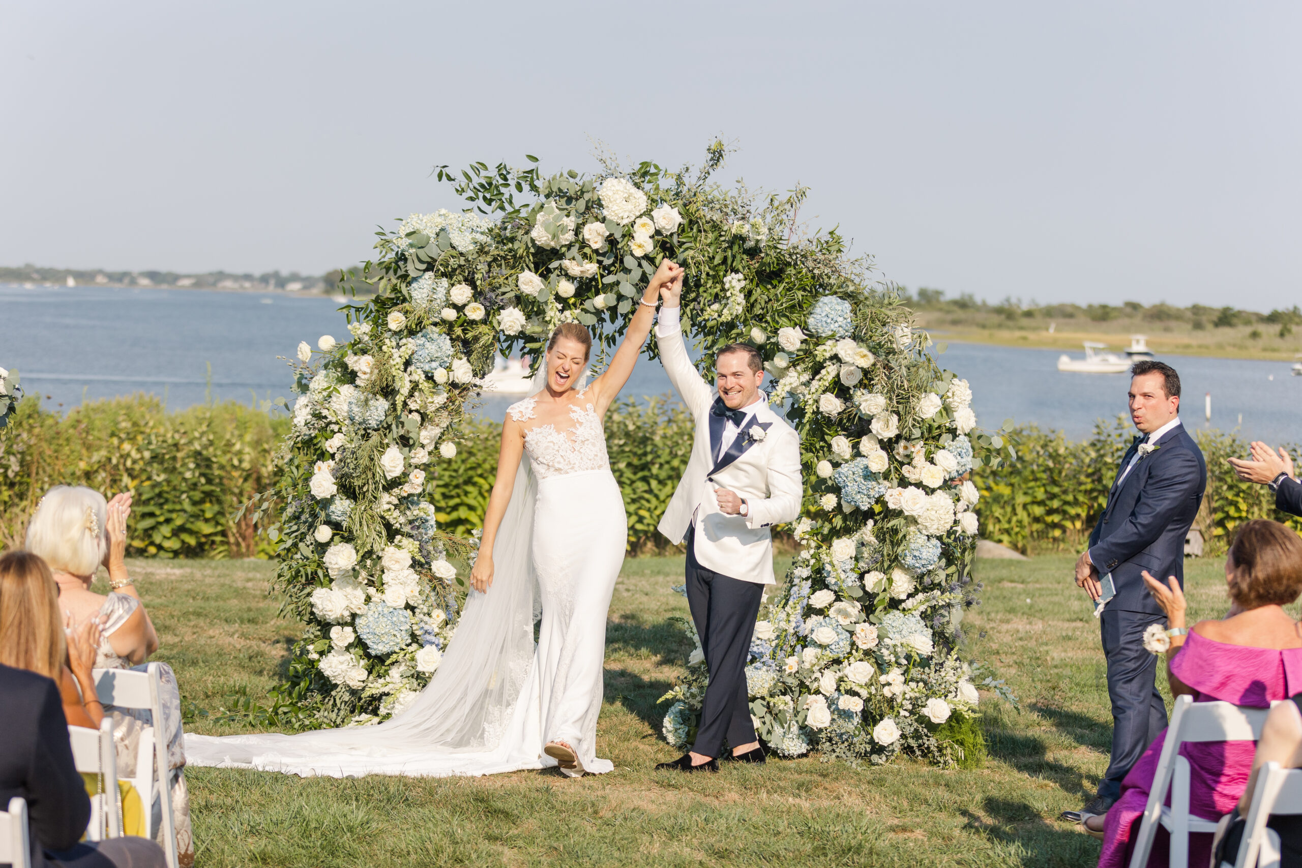A bride and groom celebrate their wedding ceremony on the lawn at the Weekapaug Inn in Westerly RI.