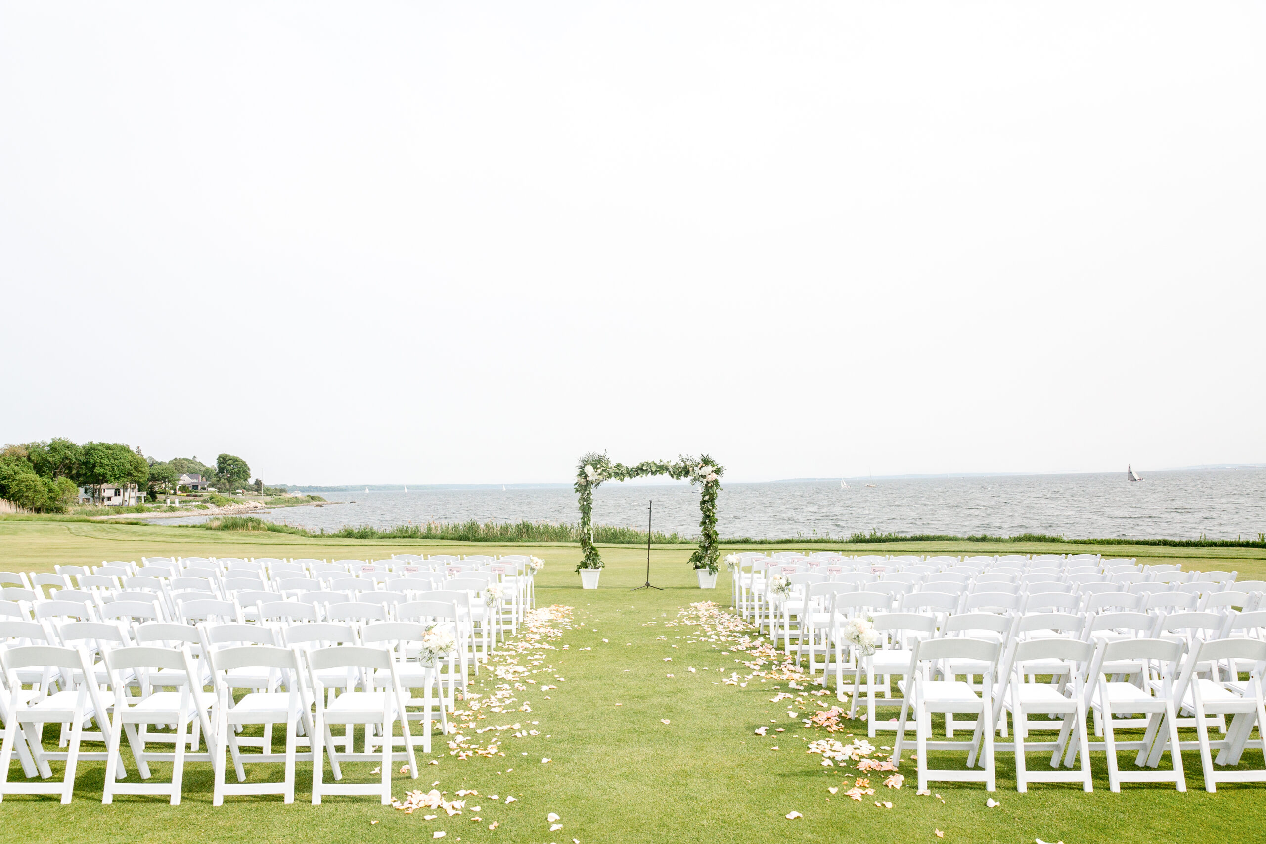 The waterfront outdoor ceremony space at Warwick Country Club overlooks the bay. 