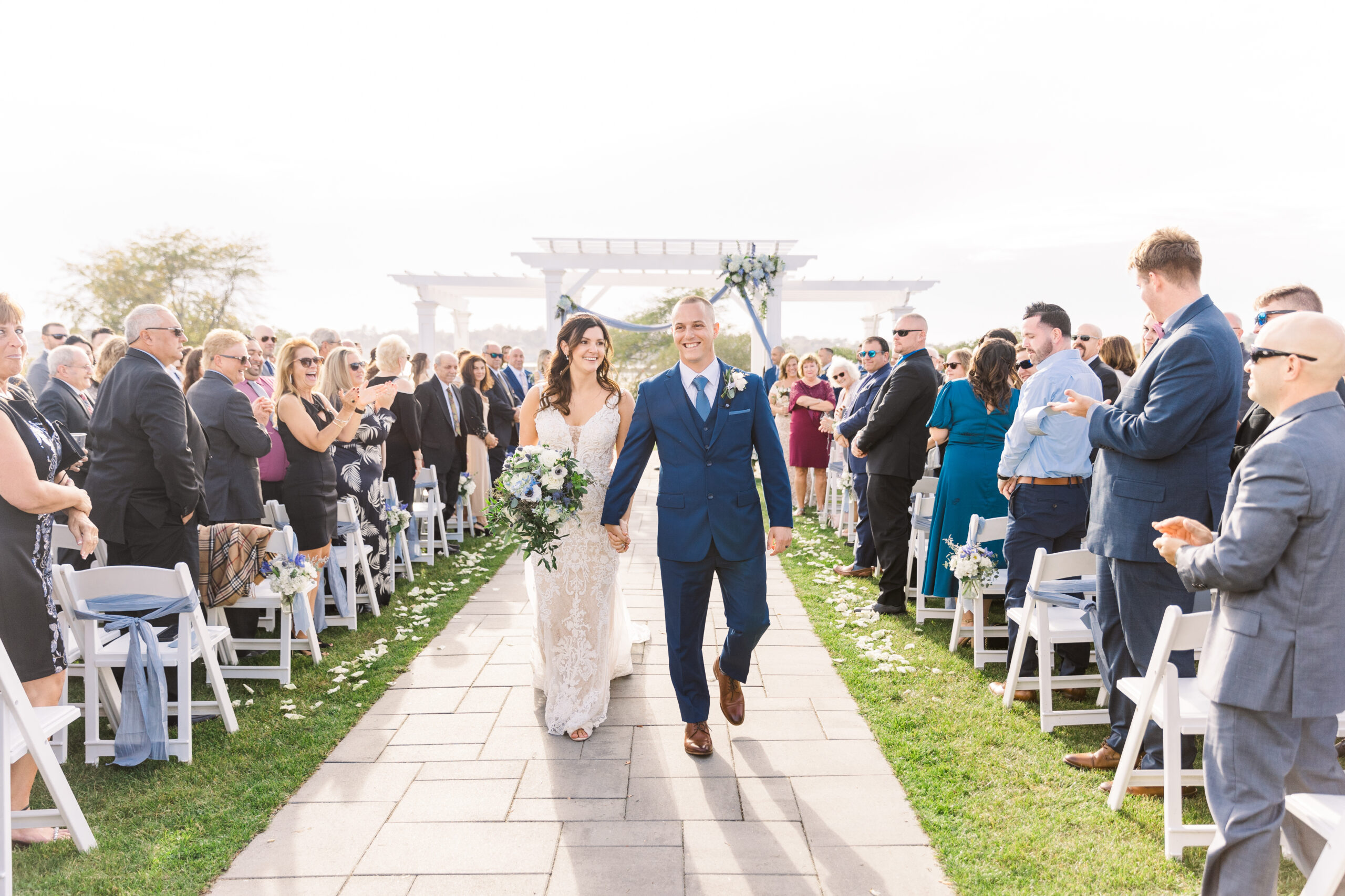 Bride and Groom walk down the aisle together at the Wyndham Newport Hotel after tying the knot on the lawn.